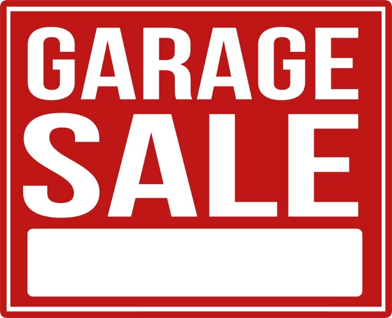 A square red garage sale sign with bold white text reading 'GARAGE SALE' and a blank white box at the bottom for writing prices or dates.